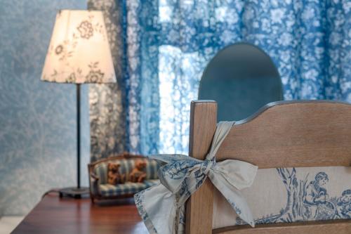a wooden bench with a bow on it next to a lamp at Villa Rosa in Dunajská Streda