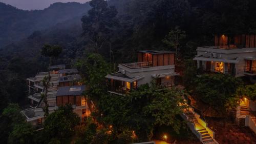 an aerial view of a house in the forest at night at Maram Resort Mamalakandam in Mamalakandam