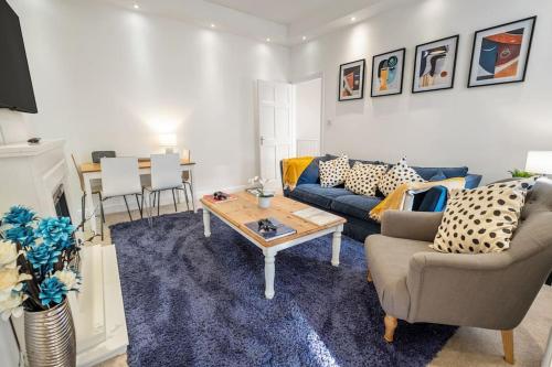 a living room with a couch and a table at Upmarket Apartment with Parking in High Heaton