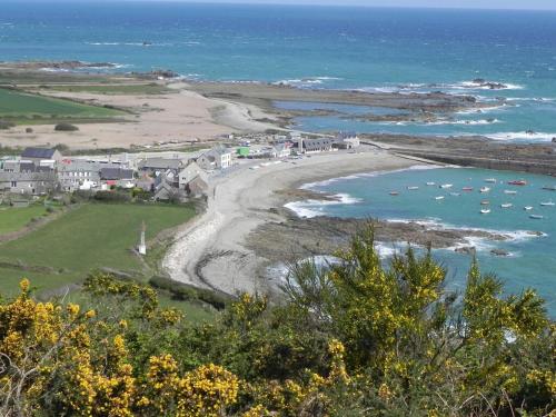 a view of a beach with boats in the water at Les Tamaris 4 étoiles in Omonville-la-Rogue
