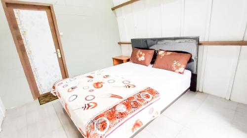 Postel nebo postele na pokoji v ubytování Tangga Bungalows