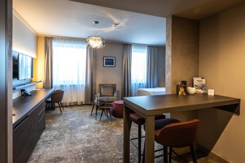 a hotel room with a table and a living room at HOTEL EUROPA in Komárno