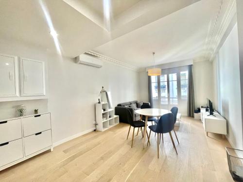 un salon blanc avec une table et des chaises dans l'établissement Pasteur by Welcome to Cannes, à Cannes