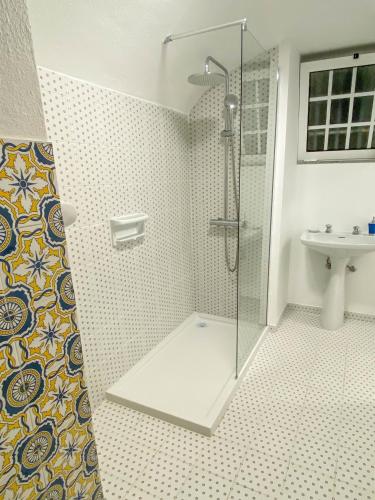 a bathroom with a shower and a sink at Solar Laginha - apartamentos e quartos in Afife