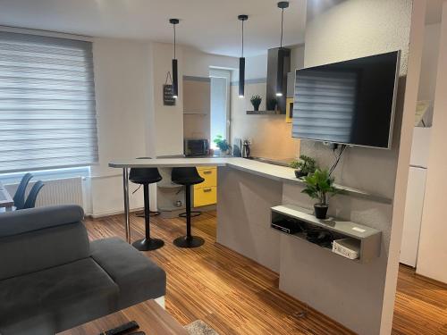 a kitchen with a counter and a table in a room at APARTMENT A&D CENTRUM in Poprad