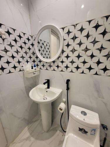 y baño con lavabo, espejo y aseo. en استديو سرير ماستر ودخول ذاتي بحي الملقا, en Riad