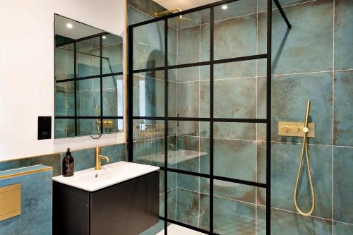 a bathroom with a shower and a sink at Finest Retreats - The Stables at Lilac Cottage in Hawling