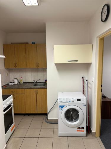 a kitchen with a washing machine in a room at Bydlení v Brumově s.r.o. in Brumow