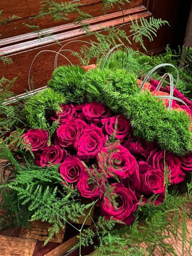 a bouquet of red roses sitting on a table at Soul Food 'Mont Morris' in New York