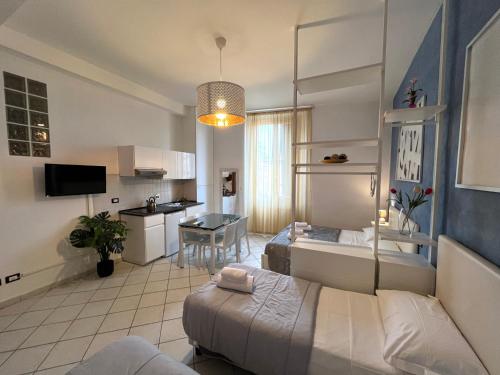 a living room with two beds and a kitchen at La Suite Rooms & Apartments in Bologna