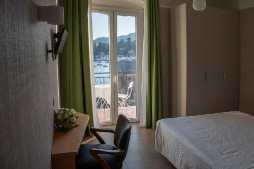 a hotel room with a bed and a large window at Hotel Italia e Lido Rapallo in Rapallo