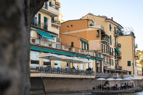 a bridge with tables and umbrellas next to a building at Hotel Italia e Lido Rapallo in Rapallo