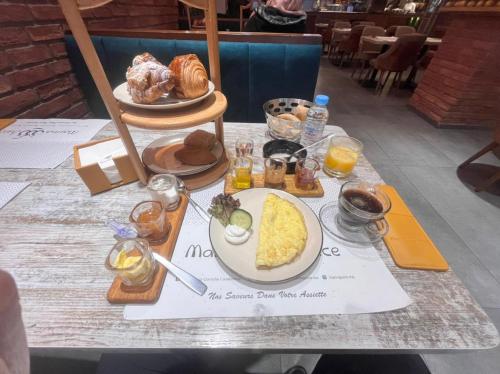 a table with a plate of breakfast food on it at PLAYA Hôtel & Restaurant Dakhla in Dakhla