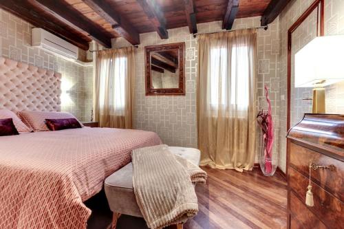 a bedroom with a bed and a dresser and a piano at ca dei zoti3 with luggage room in Venice