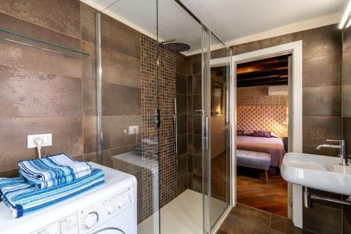 a bathroom with a shower and a sink and a tub at ca dei zoti3 with luggage room in Venice
