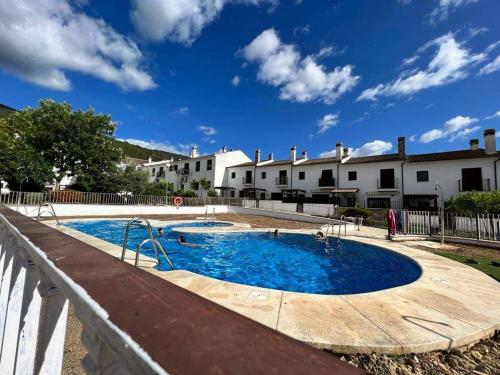 a large swimming pool in front of a building at LA CASITA DE EL BOSQUE in El Bosque