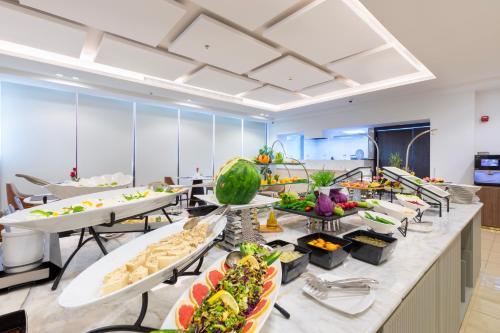 a buffet line with many plates of food at Erfad Hotel - Riyadh in Riyadh