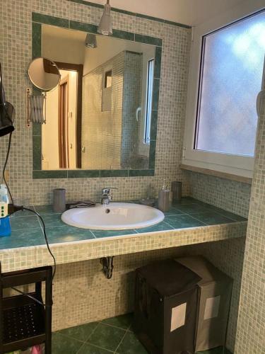 a bathroom with a sink and a mirror at Sweet Home Lunì in Vitinia