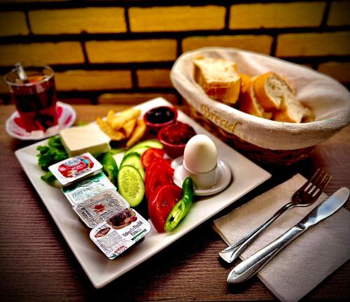 a plate of food with eggs and vegetables on a table at Otel NİL FIRAT in Bursa