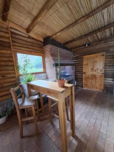 una grande camera con tavolo e sedie in legno di Mañana campestre a Chilecito