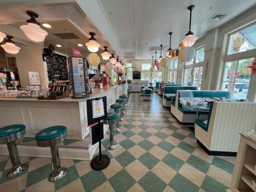 a restaurant with a bar and stools in a store at Palmetto Breeze, Golf Course New furniture, carpet in Johns Island