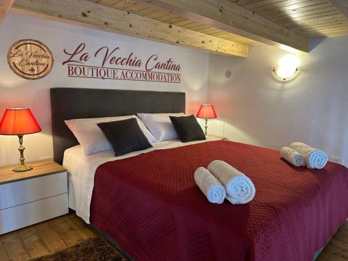 1 dormitorio con 1 cama grande y toallas. en La Vecchia Cantina, en Graniti