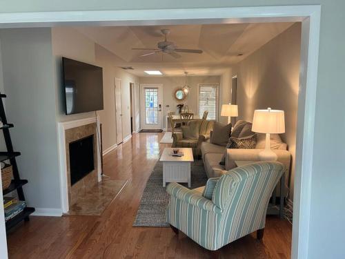 a living room with a couch and a fireplace at Palmetto Breeze, Golf Course New furniture, carpet in Johns Island