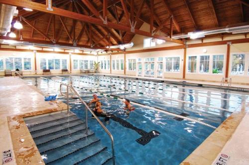 a large swimming pool with people in the water at Palmetto Breeze, Golf Course New furniture, carpet in Johns Island