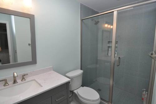 a bathroom with a shower and a toilet and a sink at Palmetto Breeze, Golf Course New furniture, carpet in Johns Island