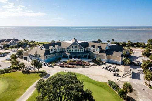 an aerial view of a house with the ocean in the background at Palmetto Breeze, Golf Course New furniture, carpet in Johns Island