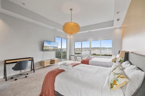 a bedroom with two beds and a flat screen tv at Piermont Waterfront Villa with Hot Tub in Piermont