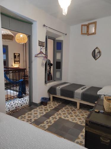 a bedroom with a bed in a room at Vallparadis Pension Familiar" FIRDAUS" in Chefchaouene