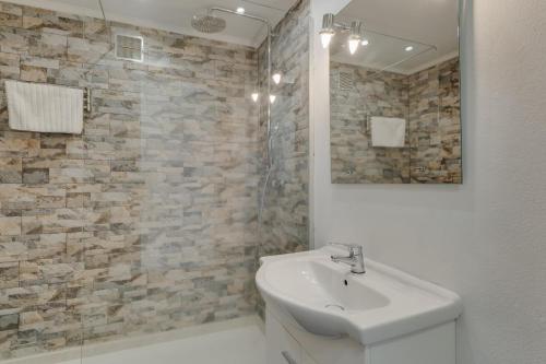 a white bathroom with a sink and a mirror at Bahia Top Floor in Funchal