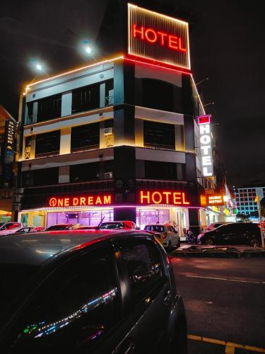 a hotel with neon signs on the side of a street at One Dream Hotel in Petaling Jaya