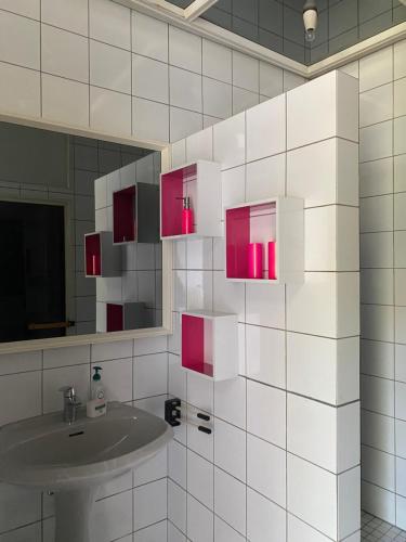 a bathroom with a sink and a mirror at Weingut Martinshof in Sankt Ulrich