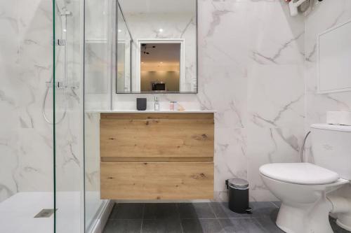 a bathroom with a toilet and a sink and a shower at Très bel appartement pour 4 aux portes de Paris in Aubervilliers