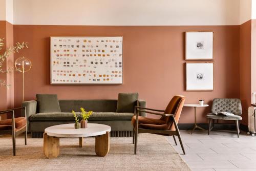 a lobby with a couch and chairs and a table at Sonder The Chorus in Nashville