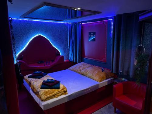 a bedroom with a bed in a room with purple lights at Apartmán Mair Pardubice in Pardubice