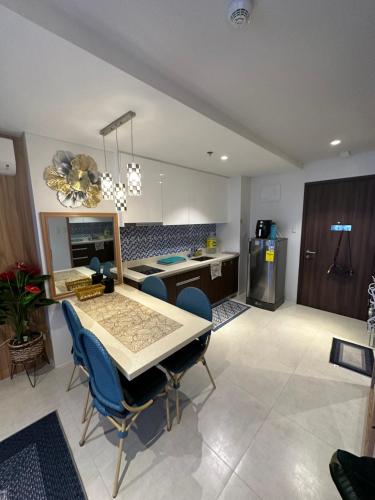 a kitchen with a table and chairs in a room at 14DC Tambuli Seaside Living in Lapu Lapu City