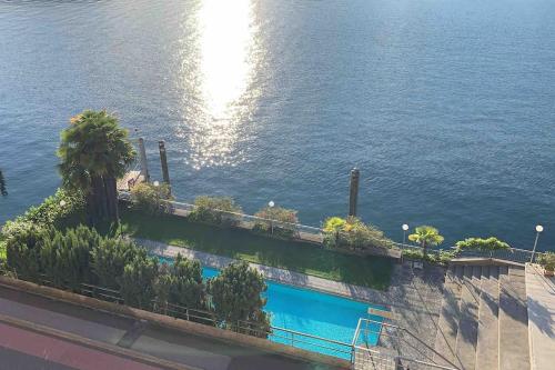 a swimming pool with a view of the water at Exclusive Lakeside Apartment with Amazing View in Gambarogno