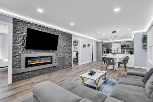a living room with a couch and a fireplace at Luxury 3BR House in Charlotte in Charlotte