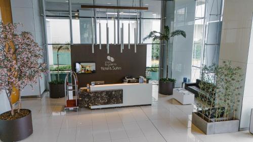 a lobby with potted plants in a building at Paseo La Galería Hotel & Suites in Asuncion