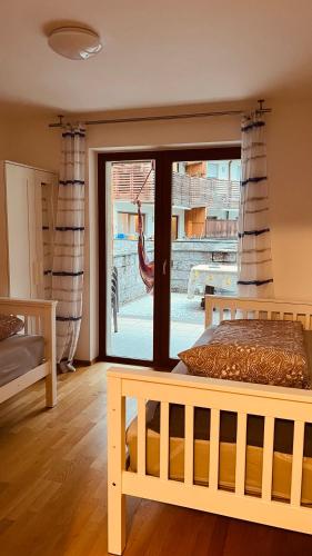 a bedroom with a bed and a sliding glass door at Appartement Alois in Bressanone