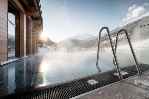a hot tub with a view of a mountain at Das Central – Alpine . Luxury . Life in Sölden