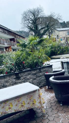 a patio with a table and chairs and plants at Appartement Alois in Bressanone