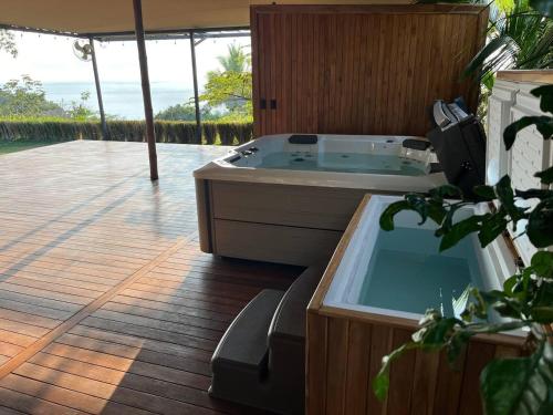 a jacuzzi tub sitting on a deck with a patio at HBG Glamping community Yoga & Wellness space in Santa Teresa Beach
