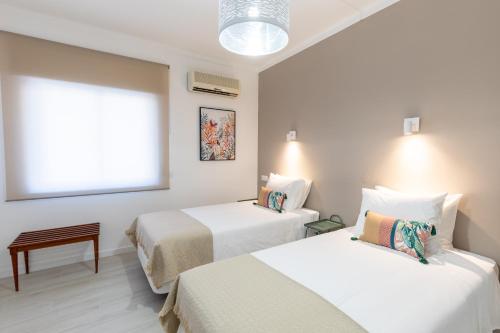Ένα ή περισσότερα κρεβάτια σε δωμάτιο στο Faro Guest Apartments