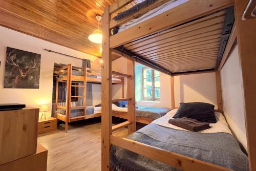 a bedroom with two bunk beds in a house at Chalet Le Loup - charming Tignes ski chalet in a superb location in Tignes