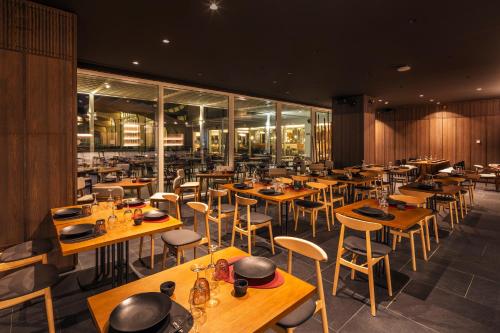 a dining room with wooden tables and chairs at Barceló Playa Blanca in Playa Blanca