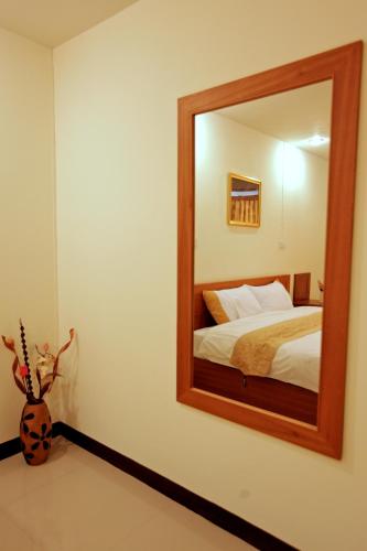 a bedroom with a large mirror and a bed at Rafael Hotel and Mansion Bangkok in Lat Krabang